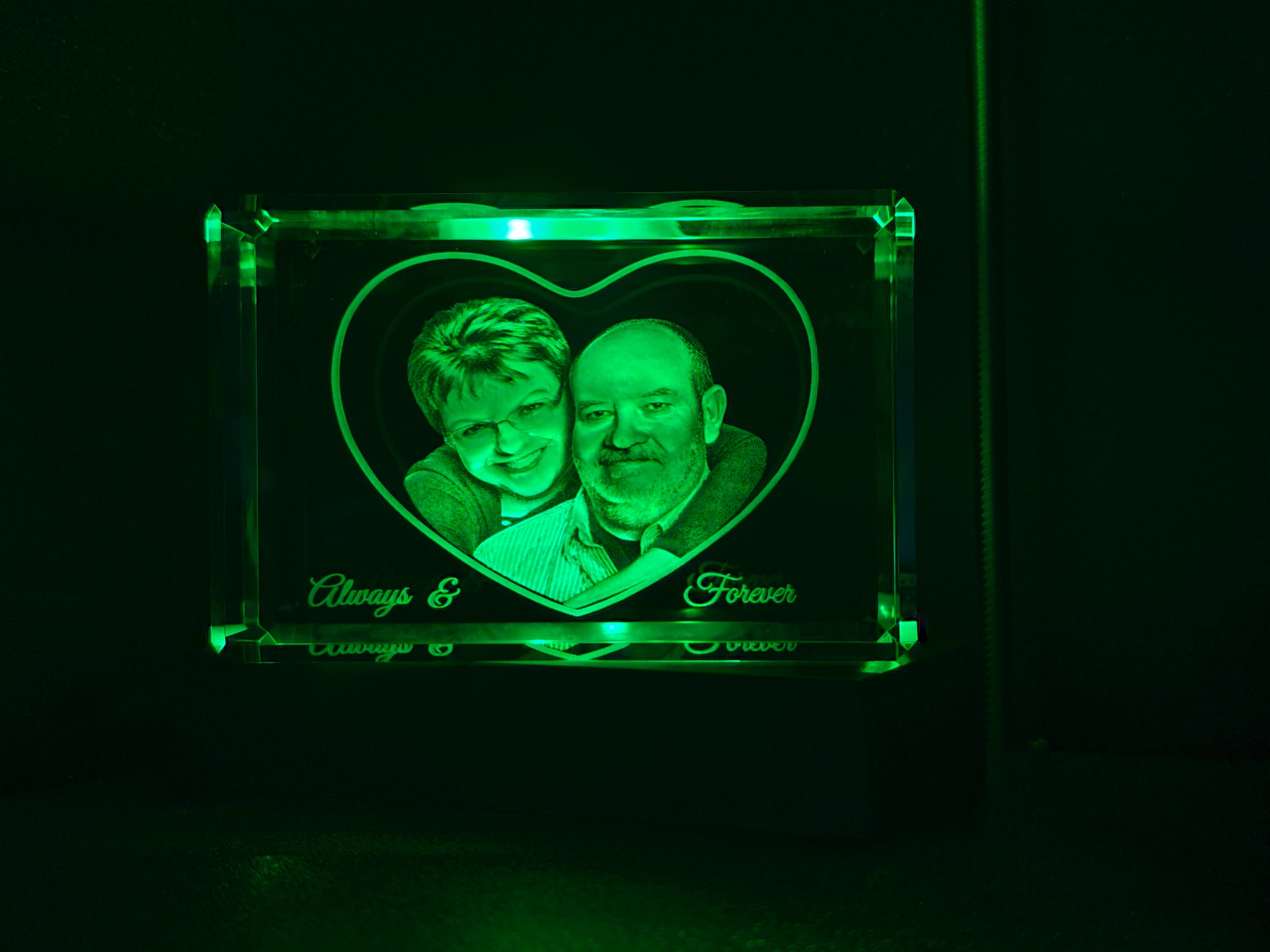 Always and Forever couple portrait engraved in a rectangular crystal under green lighting
