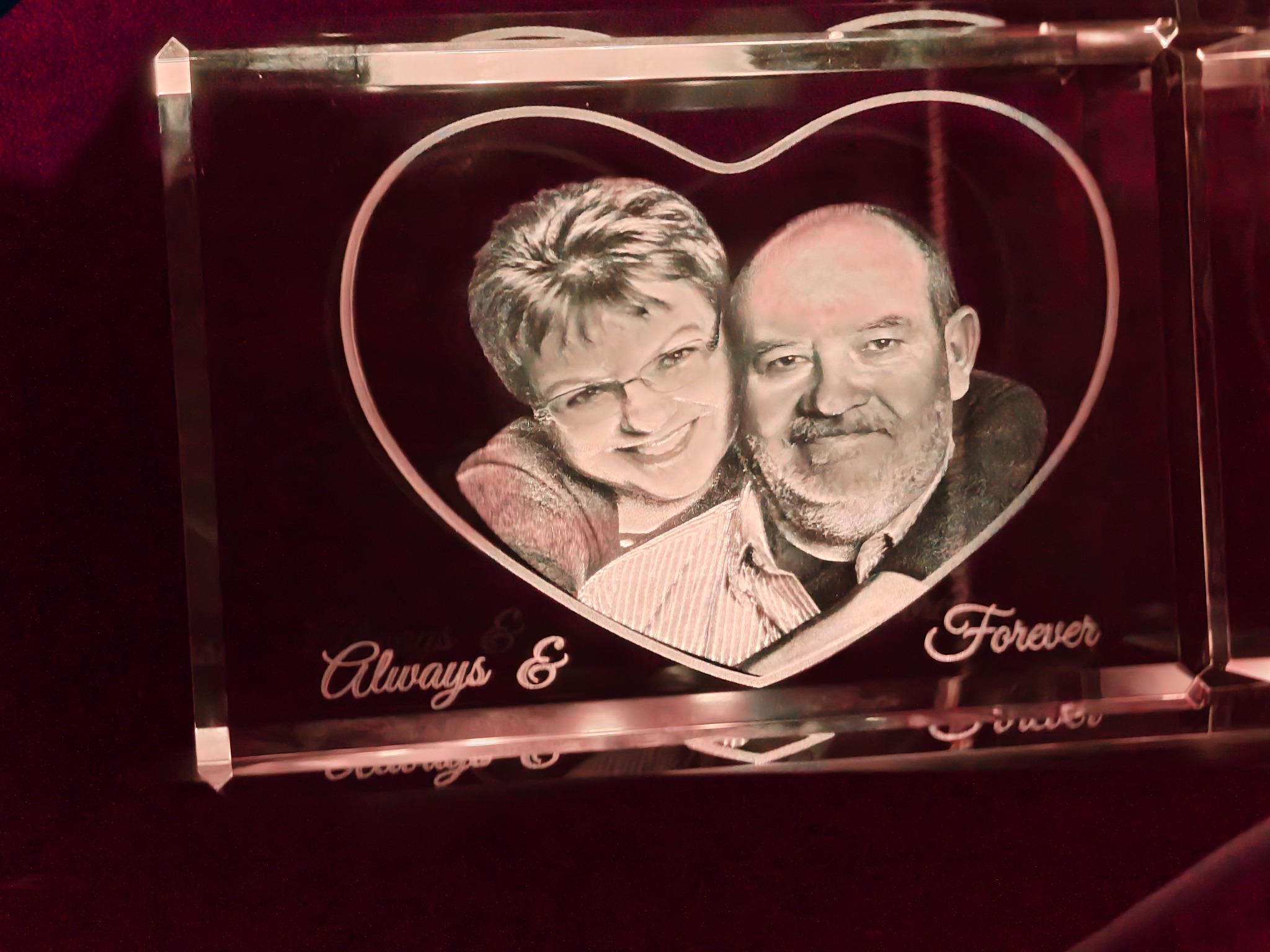 Always and Forever couple portrait engraved in a rectangular crystal under warm red lighting
