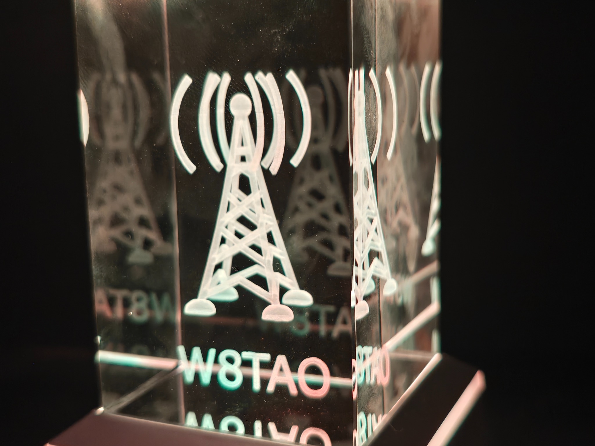 Angled view of a radio tower and W8TAO call sign engraved in a rectangular crystal